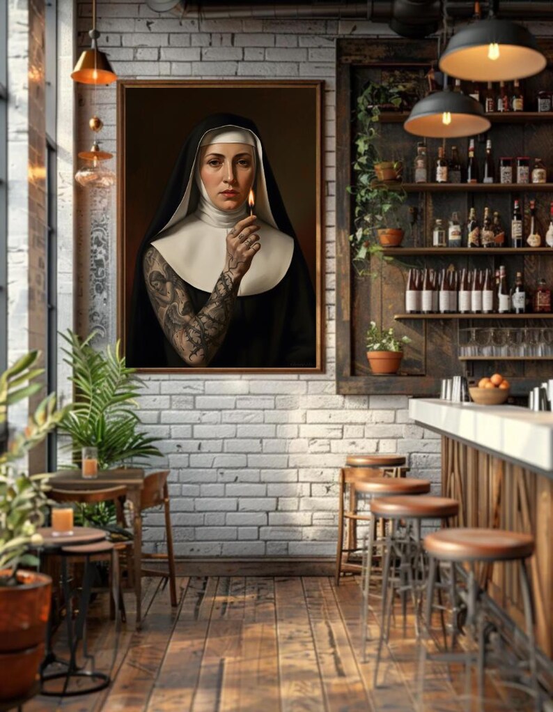 May include: A framed portrait of a nun holding a lit match, with intricate tattoos on her arm. The artwork is displayed in a bar setting with wooden stools, shelves of bottles, and hanging lights, creating a unique and artistic ambiance.