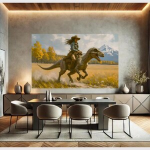 May include: A large framed canvas print depicting a person riding a dinosaur through a field. The person wears a cowboy hat and denim shirt. The background features yellow trees, a mountain, and a blue sky. The artwork is displayed in a modern dining room.