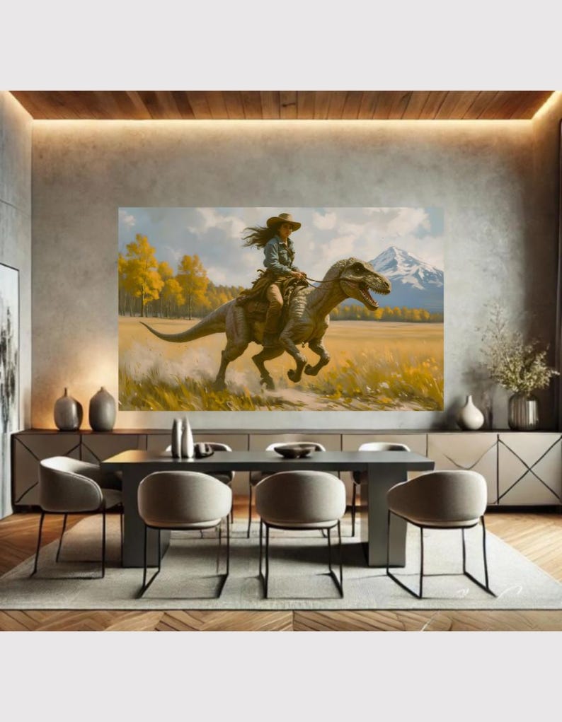 May include: A large framed canvas print depicting a person riding a dinosaur through a field. The person wears a cowboy hat and denim shirt. The background features yellow trees, a mountain, and a blue sky. The artwork is displayed in a modern dining room.