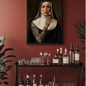May include: A framed portrait of a nun holding a lit match, with a full sleeve tattoo. Below, a black metal bar cart displays various bottles of liquor, glassware, and bar tools against a red wall.