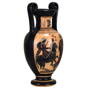 Puede incluir: Jarr&oacute;n de cer&aacute;mica de estilo griego negro y rojo con dos asas y una escena pintada en blanco y negro de un jinete a caballo. El jarr&oacute;n tiene una base negra y un cuerpo de color crema con detalles pintados en negro y rojo.
