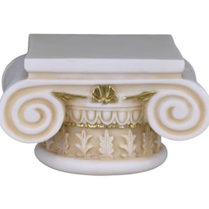 May include: A white and gold Ionic column capital. The decorative architectural element features scrolled volutes, gold accents, and detailed carvings. The top is a flat, rectangular surface.