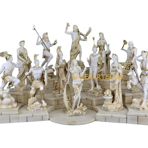 May include: A set of 12 white marble Greek god and goddess statues with gold accents. The statues are arranged in a semi-circle on a white marble base. Each statue is labelled with the name of the god or goddess.