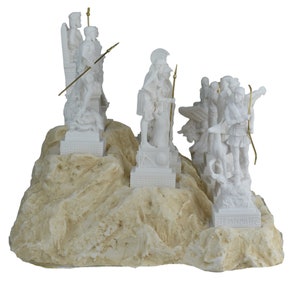 May include: White alabaster sculpture of Greek gods and goddesses standing on a rocky base. The sculpture features figures of Zeus, Athena, Artemis, Apollo, and Hermes.