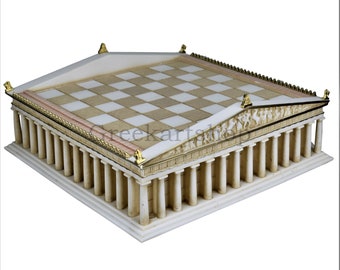 May include: A white and gold chessboard set in the shape of a Greek temple. The board is made of marble and has a checkered pattern. The temple has columns and a roof with a decorative frieze.