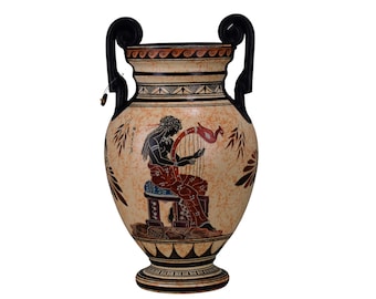 May include: A black and white ceramic amphora with black handles. The amphora is decorated with a red and white scene of a woman playing a lyre. The scene is surrounded by a black and white geometric pattern.