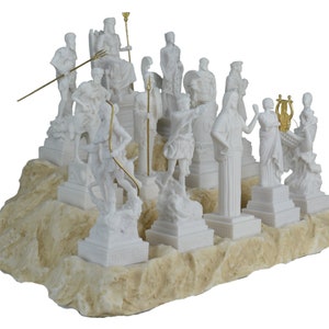 May include: A white marble sculpture set of the twelve Greek gods and goddesses. The figures are arranged on a white marble base with a textured surface. The sculptures are detailed and realistic, with each god and goddess depicted in their traditional pose.