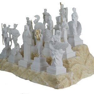 May include: A white alabaster sculpture set of the twelve Greek gods and goddesses on a white and beige stone base. The sculptures are all standing on individual bases and are arranged in a semi-circle.