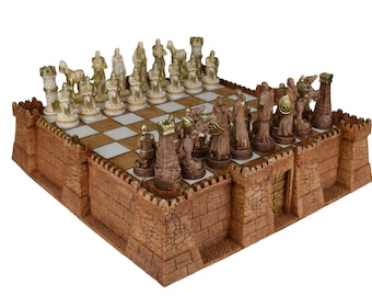 May include: A brown and gold chess set with a castle-shaped board. The chess pieces are made of resin and feature a medieval theme.