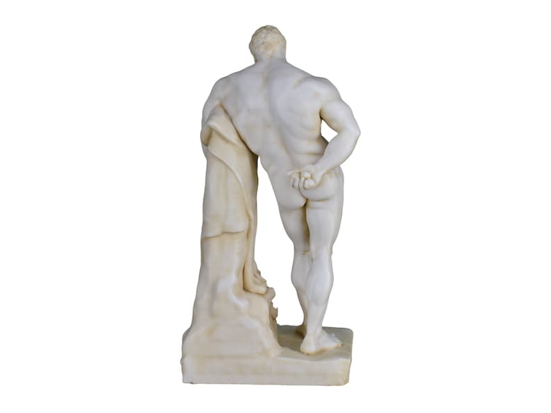 May include: A marble statue of a muscular figure, viewed from the back. The statue is off-white with detailed musculature and a draped cloth. It stands on a rectangular base, showcasing classical art.