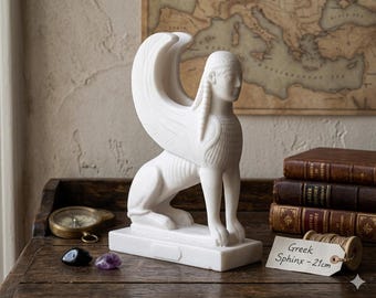 May include: A white marble sphinx statue with large wings, seated on a rectangular base. The statue is approximately 8 inches tall and is labeled "Greek Sphinx - 21cm". The background includes antique books, a compass, and a vintage map.