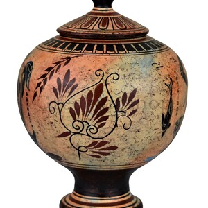 May include: A hand-painted ceramic vase with a lid, featuring a floral design in shades of brown and orange on a cream background. The vase has a round body and a pedestal base.