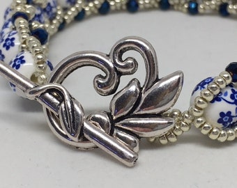 Braccialetto di perline di fiori in ceramica fatto a mano, perline di semi in argento e cristallo blu - Italia