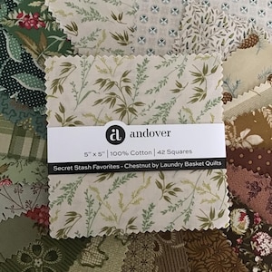 May include: A stack of 42 fabric squares measuring 5 inches by 5 inches, labeled Andover Secret Stash Favorites - Chestnut by Laundry Basket Quilts. The 100% cotton squares feature various botanical, floral, and geometric patterns in shades of green, brown, and cream with pinked edges.