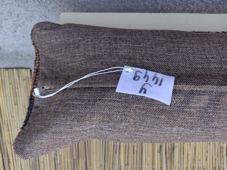 May include: A brown pillow with a white tag that says "5441 C".