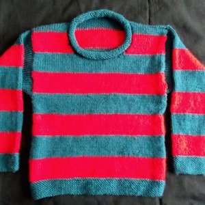 Hand knitted jumper in acrylic Aran yarn. Red and green stripes. Approx 6-7 years.