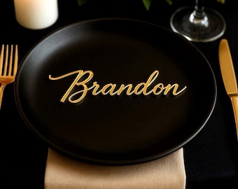 May include: A black plate with a gold name card that reads "Brandon".