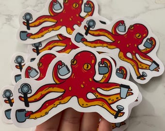 May include: A stack of red octopus stickers with yellow accents. Each octopus is holding a coffee cup and a coffee maker. The stickers are on a white surface.