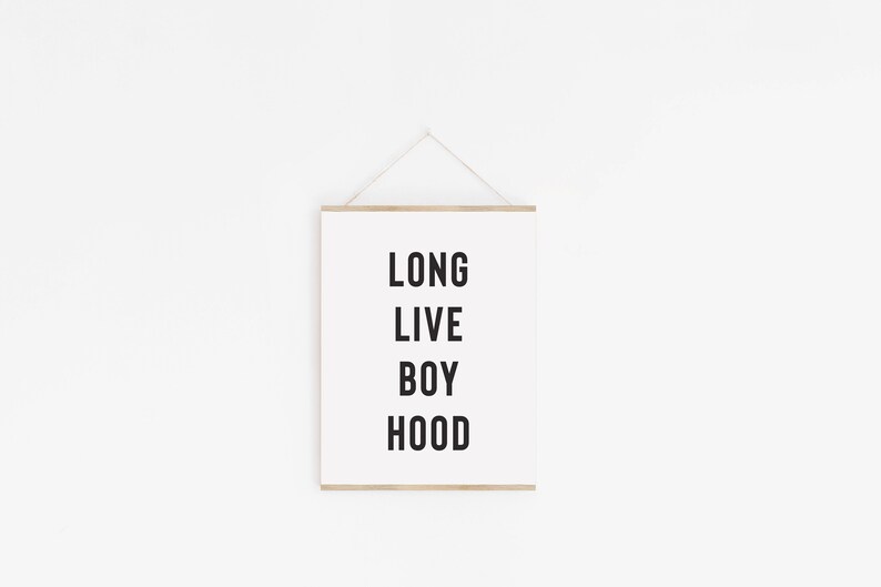 May include: A white framed print with the text "LONG LIVE BOY HOOD" in black lettering.