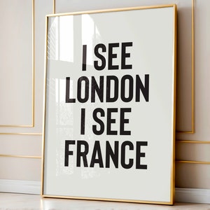 May include: A framed print with the text "I see London I see France" in black bold letters on a white background.