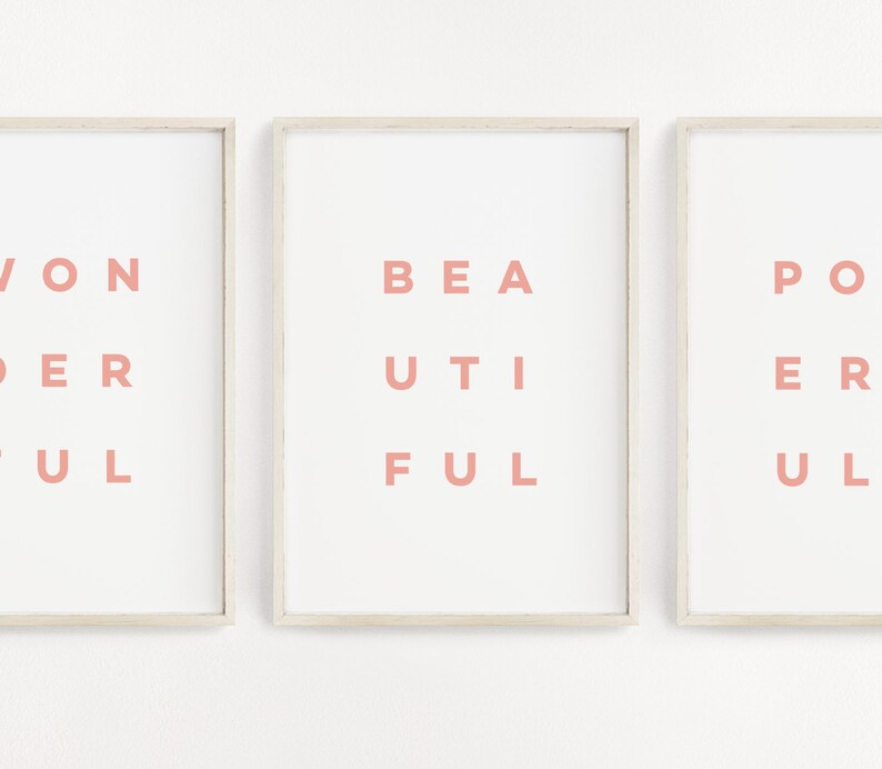 May include: Three framed prints with the words "Wonderful", "Beautiful", and "Powerful" written in pink letters on a white background.