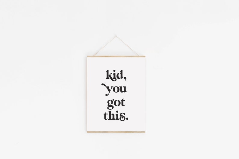 May include: A white framed print with black text that reads "kid, you got this."
