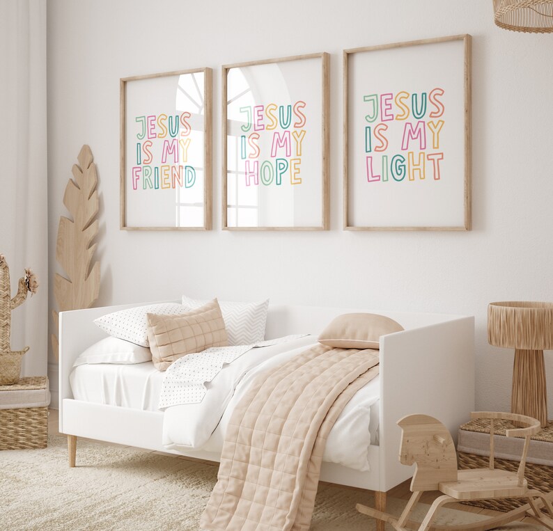 May include: Three framed prints with the text "Jesus is my" followed by "Friend", "Hope", and "Light". The prints are in a white room with a white bed and a wooden rocking horse.