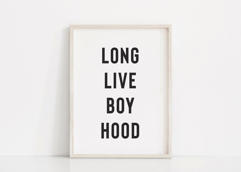 May include: A white framed print with black text that reads "LONG LIVE BOY HOOD".