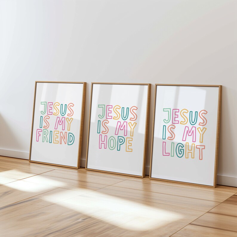 May include: Three framed prints with a white background and gold frames. Each print features the text "Jesus is my" in colorful outlined letters, followed by "Friend", "Hope", and "Light".