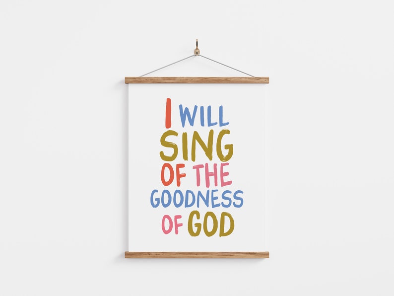 May include: A framed print with the text "I WILL SING OF THE GOODNESS OF GOD" in colorful, handwritten font.