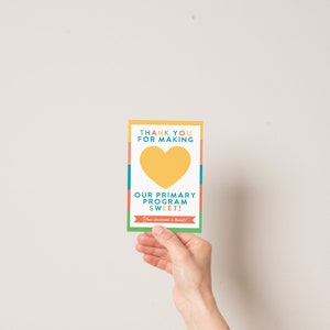 May include: A colorful thank you card with a yellow heart and the text "Thank you for making our primary program sweet! You deserve a treat!"