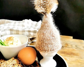 Knitted egg cosy with feathers, egg warmer for Easter