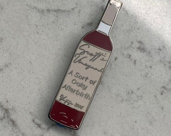 A sort of oaky afterbirth wine bottle pin, the office pin, enamel pin