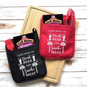 May include: Two red and black oven mitts with pockets. The mitts have a white graphic that says "I just want to drink beer and smoke meat".