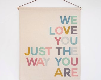 We love you just the way you are wall hanging. In muted pastel or Rainbow bright colours.