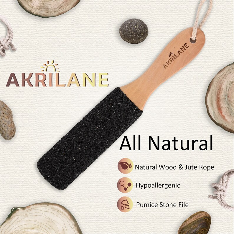 May include: A black pumice stone foot file with a wooden handle and jute rope. The handle is labeled "Akrilane" and the product is described as "All Natural" with the following features: Natural Wood & Jute Rope, Hypoallergenic, Pumice Stone File.