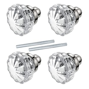 May include: Four clear glass cabinet knobs with a faceted design and silver-toned metal bases. Two silver screws are also included. These decorative knobs are suitable for furniture and home decor projects.