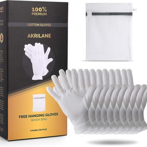 May include: A set of 10 white cotton gloves, packaged in a black box with gold accents. The box features the text "100% Premium Cotton Gloves Akrilene" and "Free Hanging Gloves Wash Bag 5 Pairs (10 Pcs)". The gloves are also shown in a white mesh laundry bag.