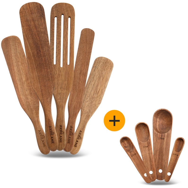May include: Set of five wooden kitchen spatulas with the word "AKRILANE" engraved on each handle, plus a set of four wooden measuring spoons with measurements in teaspoons.