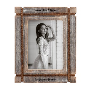 May include: Rustic wooden picture frame with a distressed gray finish, accented with rope detailing. The frame holds a black and white photograph and features the text "Your Text Here" and "Engrave Here".