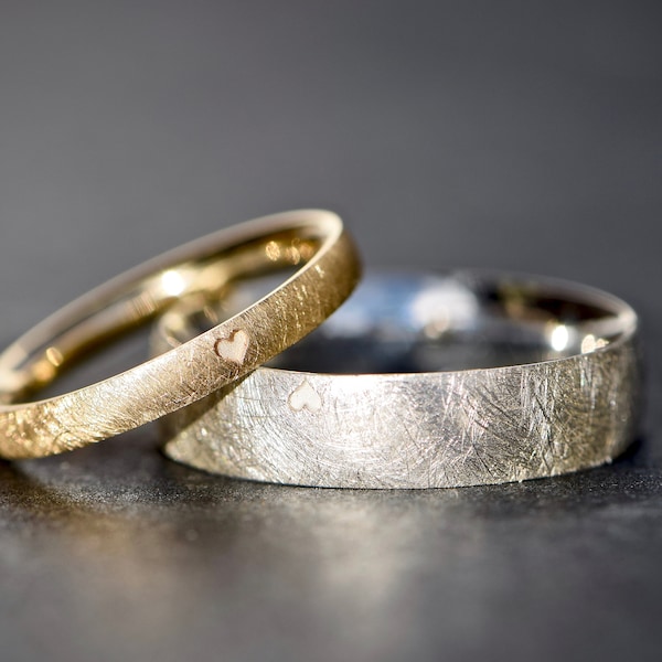 Classic wedding rings in gold and silver with a heart