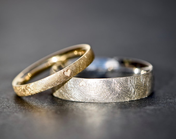 Classic wedding rings made of gold and silver with heart