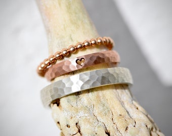 Hammered rose gold and silver wedding rings with heart engraving and ball ring