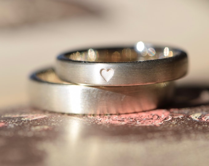 Wedding rings white gold with matte surface and heart engraving