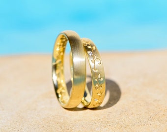 Golden wedding rings with leaf tendril