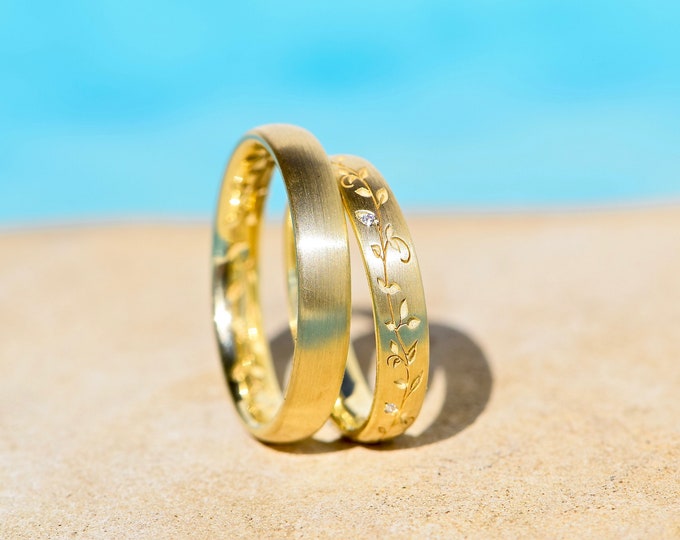 Golden wedding rings with leaf tendril