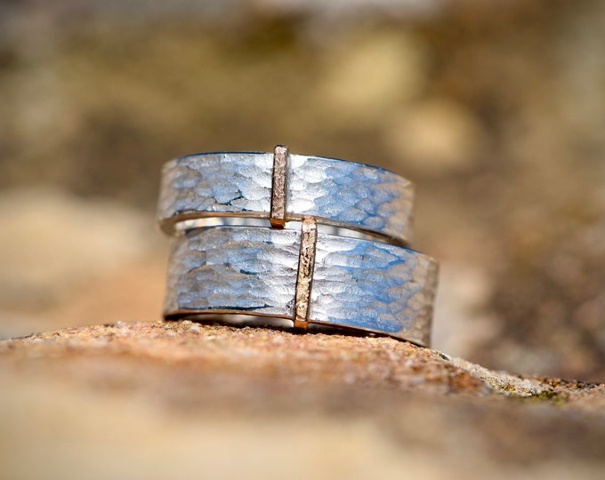 Wedding rings hammered from silver with rose gold