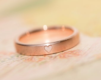 Engagement ring made of rose gold as a proposal ring with heart engraving matt