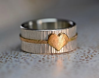 Wide silver ring with red gold heart