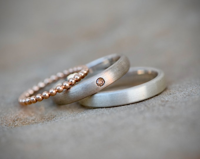 Wedding ring set made of silver with diamond and ball ring made of red gold
